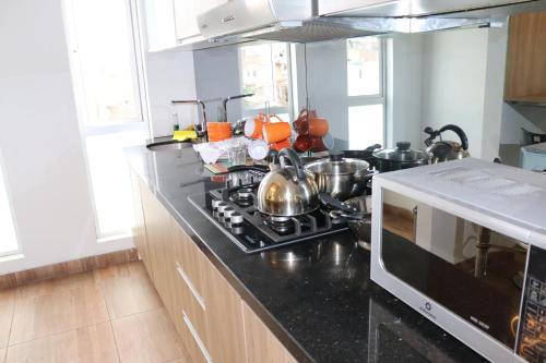 a kitchen with a stove and a microwave at Residencial Cafferata in Lima