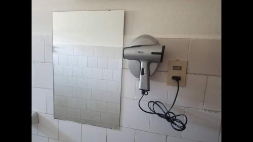 a hair dryer attached to a wall in a bathroom at Hotel Trinidad in Trinidad