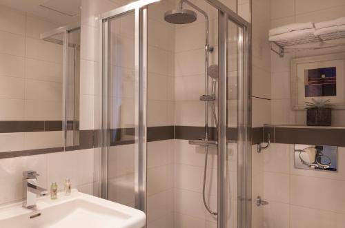 a bathroom with a shower and a sink at Verlain in Paris