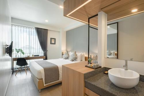 Habitación de hotel con cama y lavabo en Nap in chiangmai, en Chiang Mai