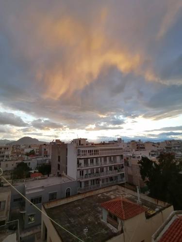 a view of a city under a cloudy sky at Hotel Korinthos in Korinthos