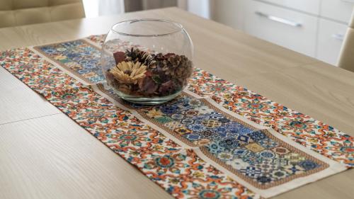 a glass vase with flowers in it on a table at Residence Rapisardi by RECEPTIO in Catania