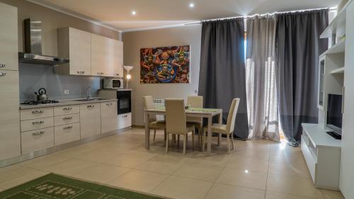 a kitchen with a table and chairs in a room at Residence Rapisardi in Catania