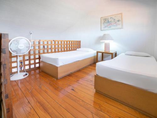 een hotelkamer met 2 bedden en een ventilator bij Hotel La Rinconada Santa Fe in Xochitepec