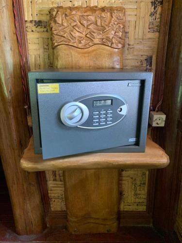 a small television on a wooden stand in a room at Kupu Kupu Garden Guest House & Cafe in Bukit Lawang