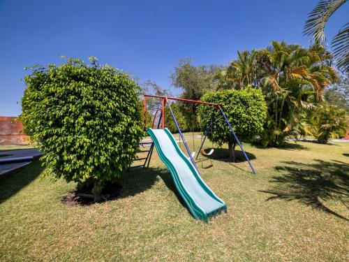 a playground with a slide in a park at Hotel La Rinconada Santa Fe in Xochitepec