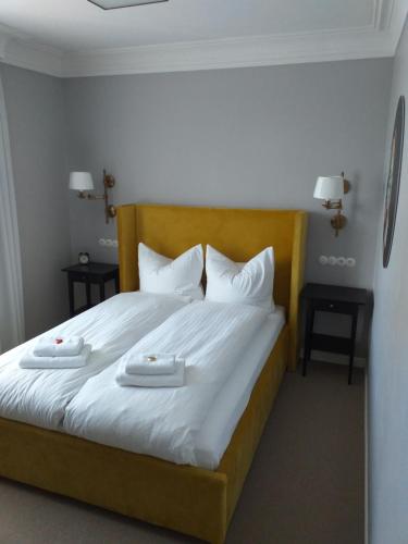 a bedroom with a bed with two white towels on it at Hotel Landgasthof Adler in Bad Krozingen