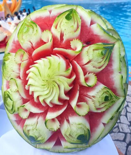 a watermelon cut in half on a table at Hotel Mediterraneo in Lignano Sabbiadoro
