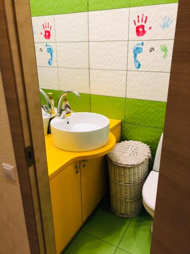 a bathroom with a sink and a toilet at Karlsons apartment in Liepāja