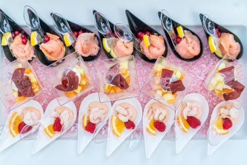 a table topped with different types of desserts at Hotel Mediterraneo in Lignano Sabbiadoro
