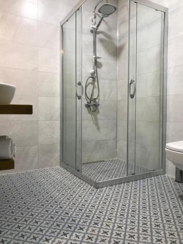 a shower with a glass door in a bathroom at Villa Veria in Çeşme