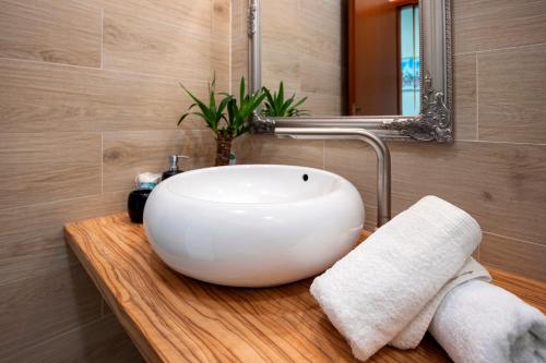 a bathroom with a white sink and a mirror at Rovinj City Apartment in Rovinj