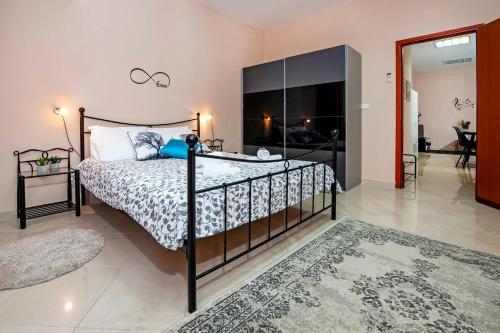 a bedroom with a bed and a glass wall at Rovinj City Apartment in Rovinj