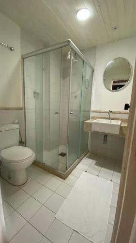 a bathroom with a shower and a toilet and a sink at Pousada Convento do Carmo in Cachoeira