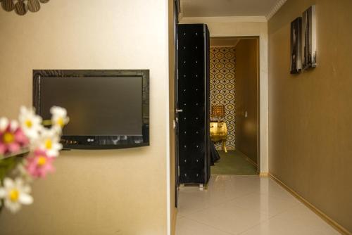 a flat screen tv on a wall in a room at Weekend Boutique Hotel in Chişinău