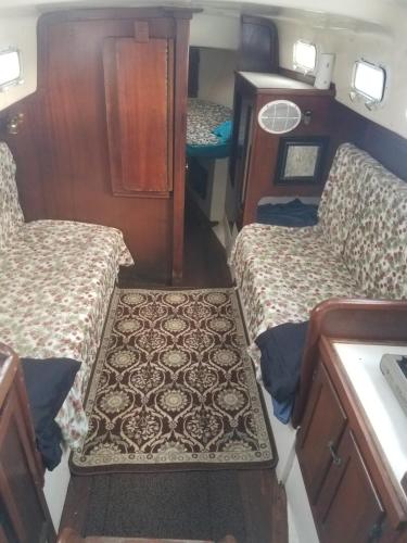 a small room with two beds and a table at Classic Sailboat 30’ in Miami