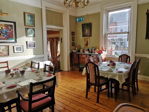 a dining room with a table and chairs and a room with at Glen Gat House in Dundalk