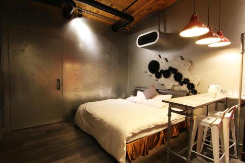 Una cama o camas en una habitación de Hotel Shumei Chiayi