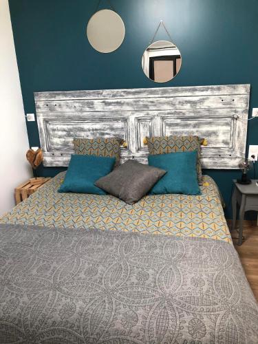 une chambre avec un grand lit aux murs bleus dans l'établissement La Charmeraie, à Marseillan