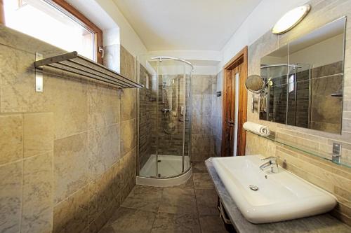 a bathroom with a sink and a shower at Penzión Dubo in Liptovský Mikuláš