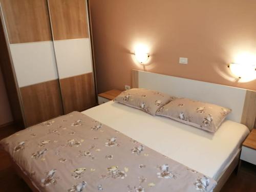 a bedroom with a bed with a pillow on it at Christian in Mali Lošinj