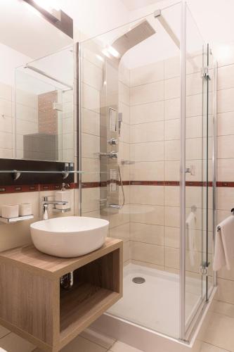 a bathroom with a sink and a shower at Bazilika alatt Panzió in Esztergom