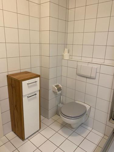 a small bathroom with a toilet and a sink at Ferienhof Kröger in Bielefeld