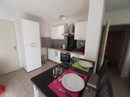 a small kitchen with a table with glasses on it at MARSEILLE CALANQUES in Marseille