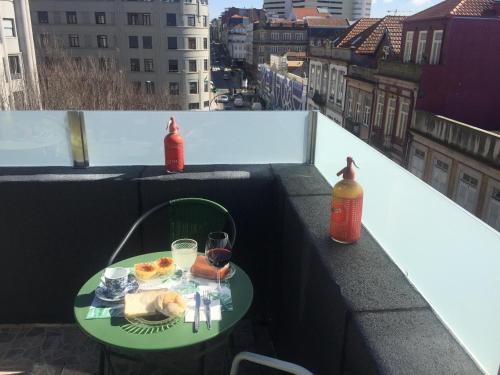 a table with a plate of food and a bottle of water at Hostel Market in Porto