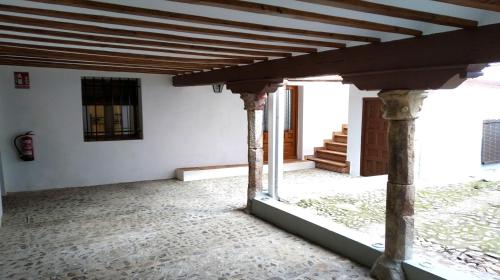 a view of the front porch of a house with columns at Alojamiento Rural La Estrella de David in Almagro