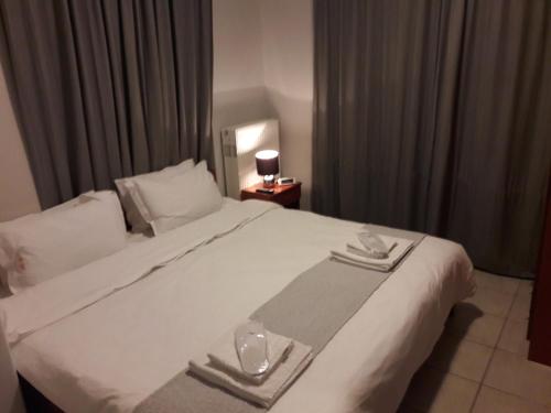 a large white bed in a hotel room at Cabo Verde in Agia Triada