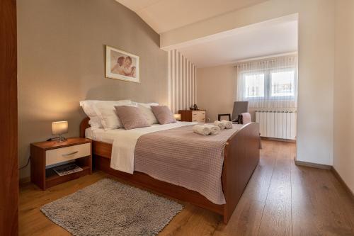 Posteľ alebo postele v izbe v ubytovaní Iva Apartment