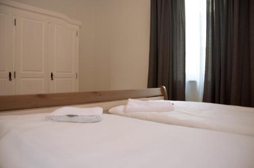 a bedroom with a bed with two towels on it at Spreewaldpension Hahn in Alt Zauche