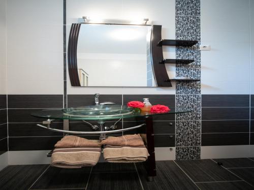 a bathroom with a glass sink and a mirror at Apartment Marina with Sea View in Lovran