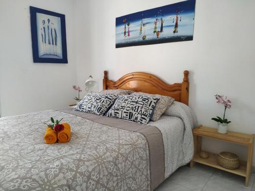 a bedroom with a bed with two pumpkins on it at Apartamentos Playa Honda in Mácher