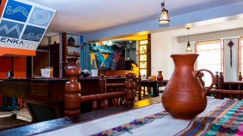 a vase sitting on a table in a restaurant at Benkawasi Experience Huaraz in Huaraz