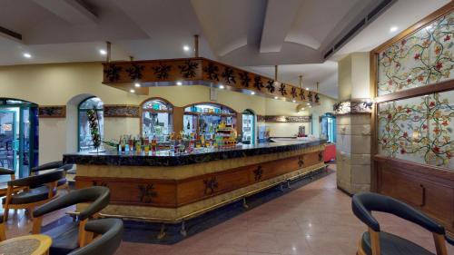 a bar in a restaurant with tables and chairs at Falcon Hills Hotel in Sharm El Sheikh