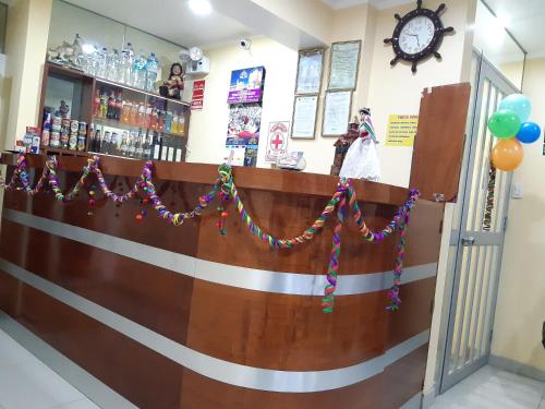 a bar with christmas decorations on the wall at Hostal Capac in Ayacucho