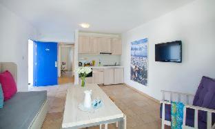 a living room with a couch and a table at Aliathon Aegean in Paphos City