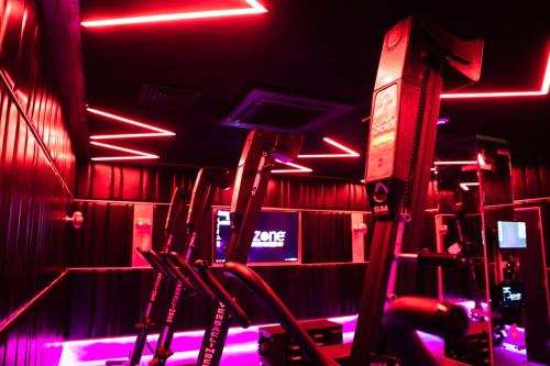 a room with red and purple lights in a gym at The Mayson in Dublin