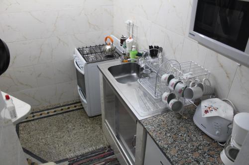 a small kitchen with a sink and a stove at Apartment Castillo in Buenos Aires