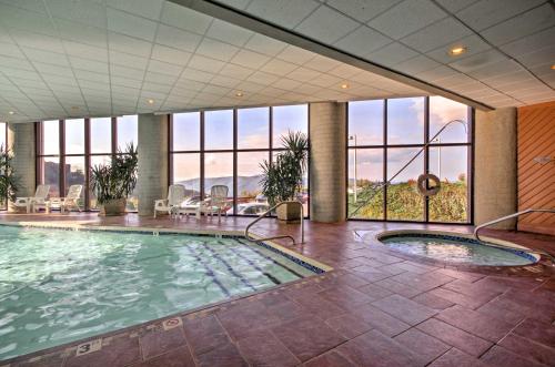 a large swimming pool in a building with windows at Less Than 4 Mi to Sugar Mtn Resort Condo with Indoor Pool! in Sugar Mountain