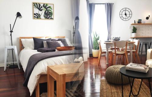 a bedroom with a bed and a dining room at Quick Stroll To The City in Geraldton