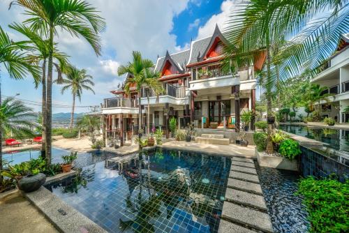 an exterior view of a resort with a swimming pool at Baan Yin Dee Boutique Resort Phuket - SHA Plus in Patong Beach