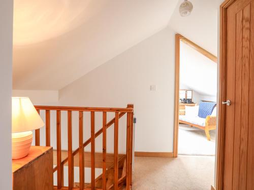 a room with a staircase and a living room at Yr Orsedd in Holyhead