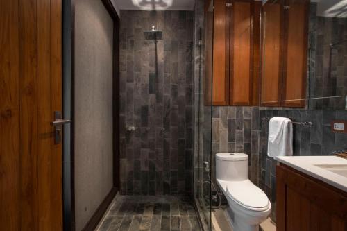 a bathroom with a shower with a toilet and a sink at LUXX Langsuan Hotel - SHA Plus in Bangkok