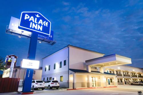 a parking inn sign in front of a building at Palace Inn Blue Federal Road in Houston