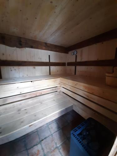 an empty wooden sauna with a clock in it at Almhütte Chalet HIRSCHFISCH in Bodensdorf