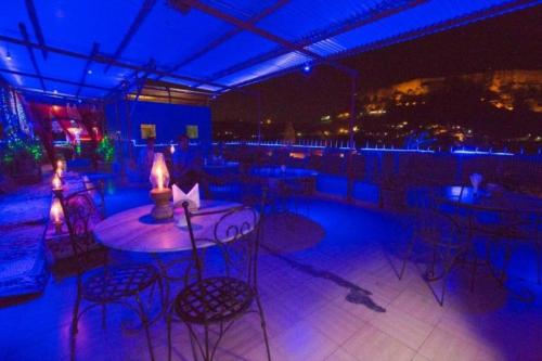 a patio with a table and chairs at night at The Blue House in Jodhpur