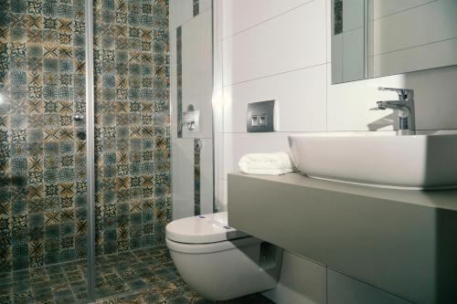 y baño con aseo blanco y lavamanos. en Acropol Of Bodrum Beach Hotel, en Ortakent